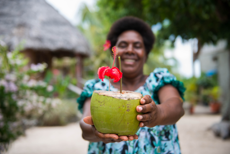A ni-Vanuatu woman holds a fresh coconut, Rocky Ridge Bungalow,Tanna Island, Tafea province, Vanuatu. Photo: Vanuatu Tourism Office/ JP Niptik