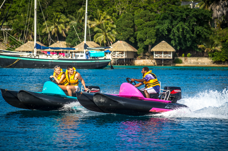 A tourist couple and a local tour guide jetskiing on Port Vila harbour. Credit: Vanuatu Tourism Office/David Kirkland